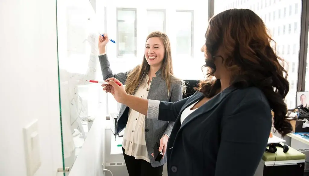 two women at whiteboard