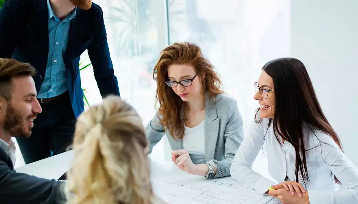 workers in a meeting, smiling