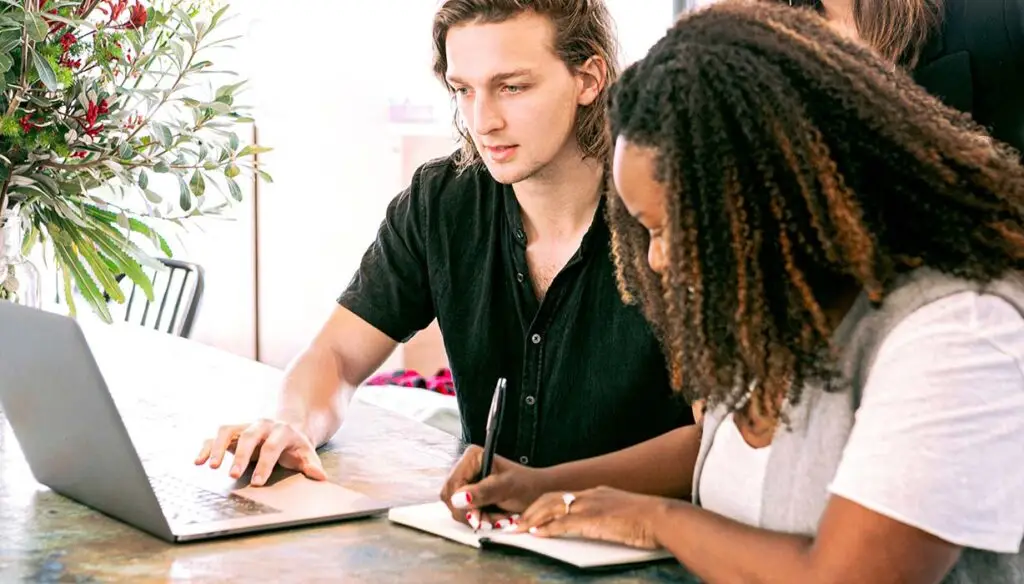 two workers taking notes