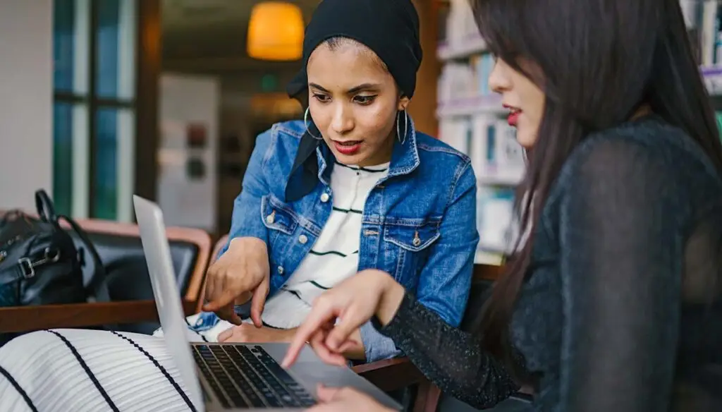 two workers at laptop