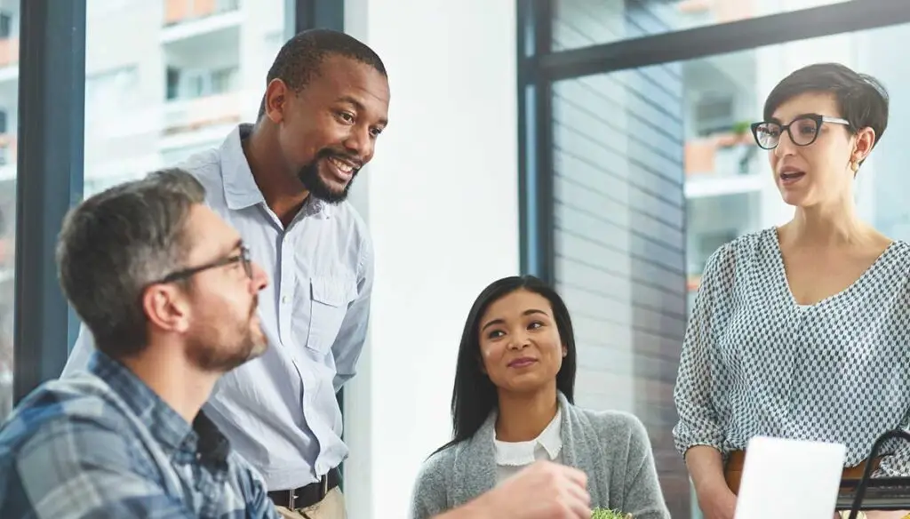 four workers discussing strategy