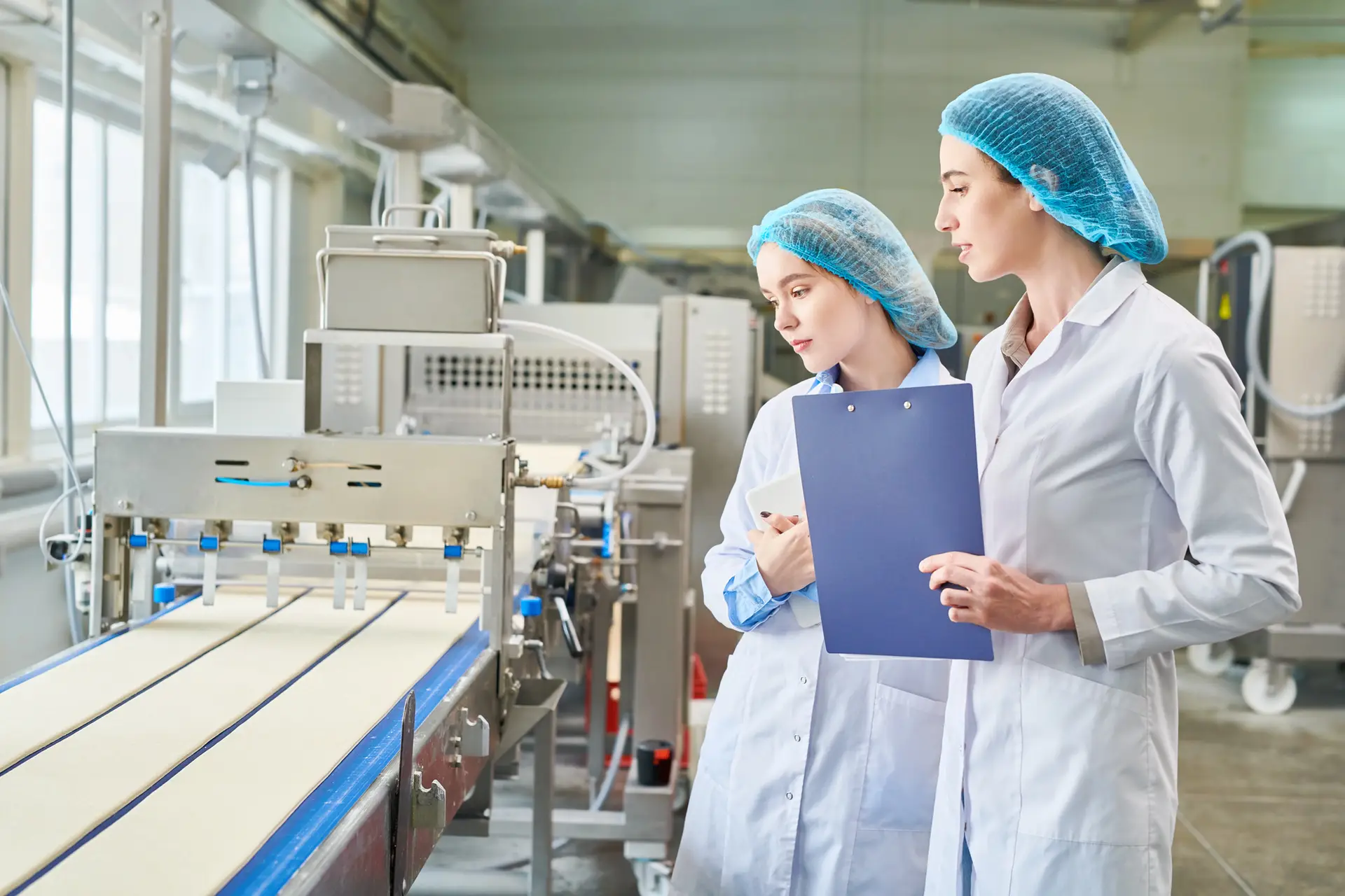 Two food tech employees working fodo manufacturing line