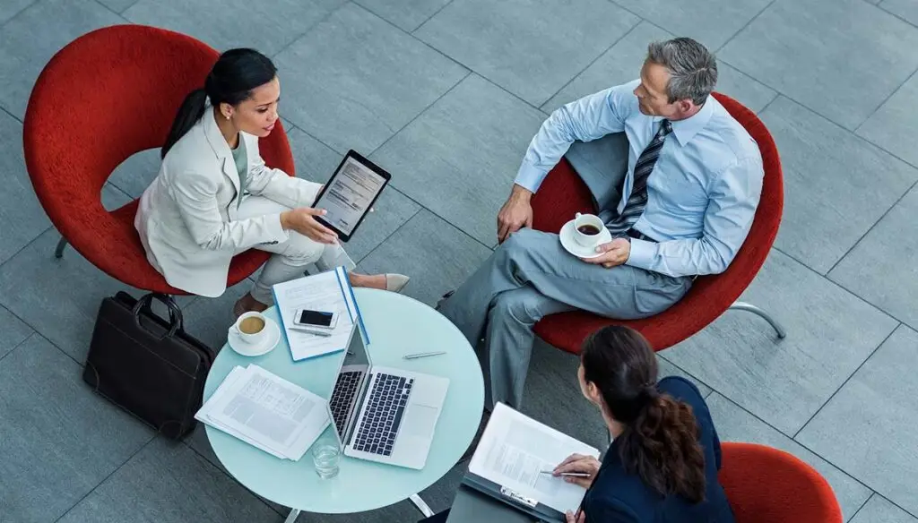three people sitting around table