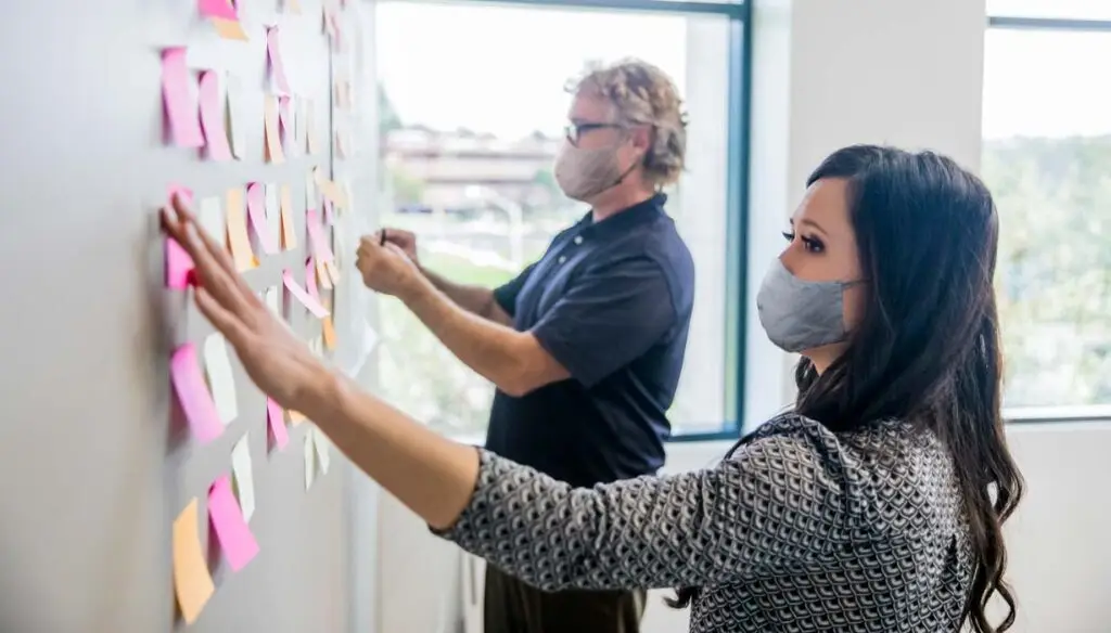 two workers at board