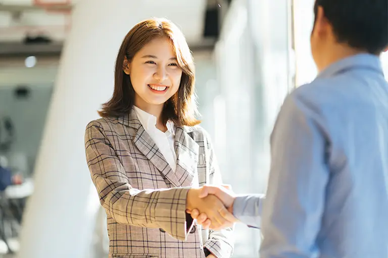 Asian woman shaking hand