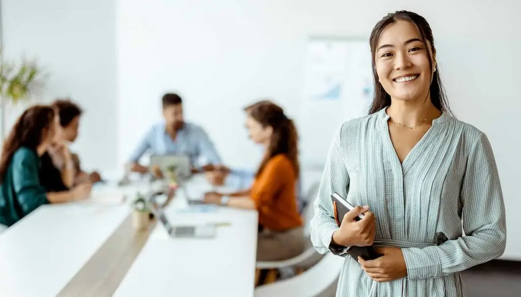 Smiling Asian woman in meeting