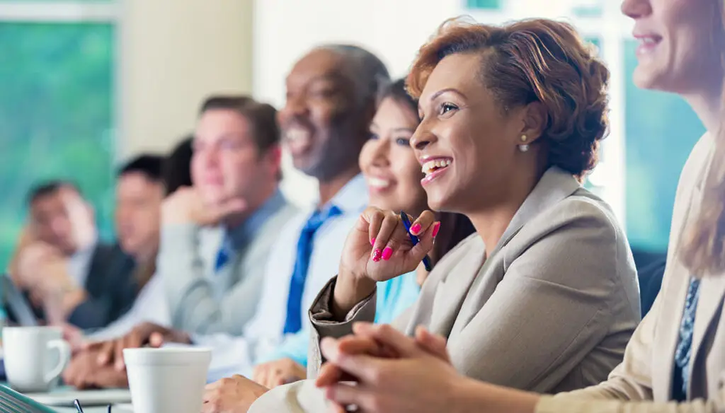 Diverse team listening to conference