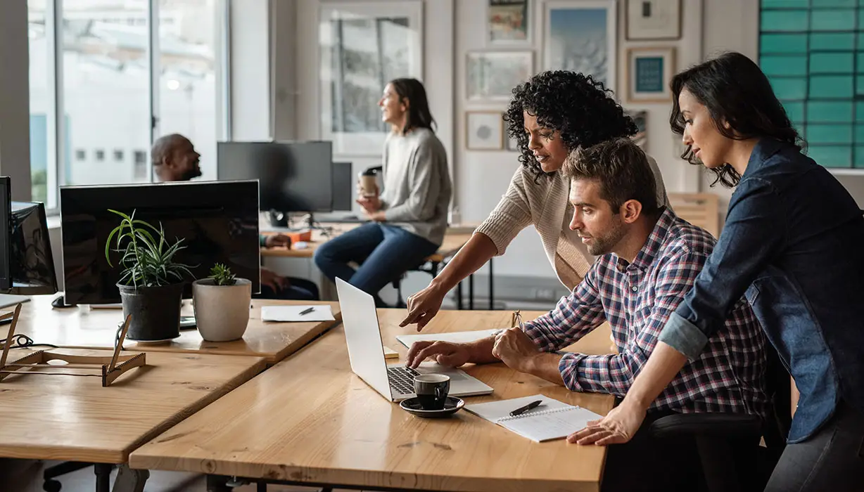 three people working together in an office
