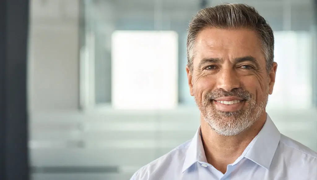 smiling man in white shirt in an office