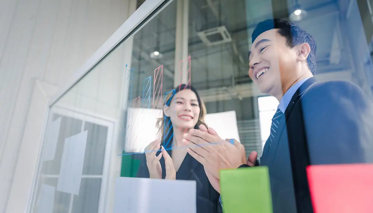 two people in an office looking through glass