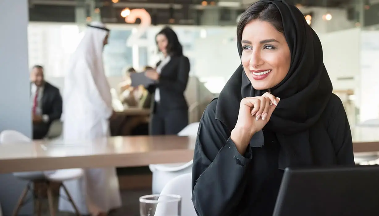 Young Emirati Businesswoman Looking Away At Conference Table