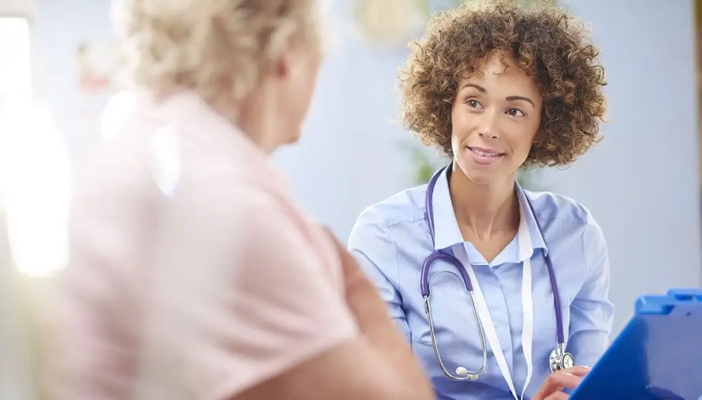 medical worker speaking with a patient